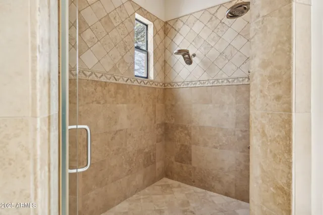 a bathroom with a glass shower door
