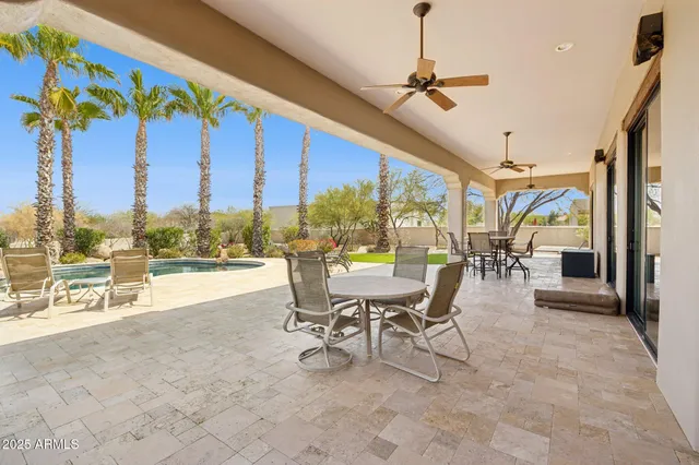 a view of tree covered with snow in front of house