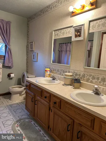 a spacious bathroom with a double vanity sink and a mirror