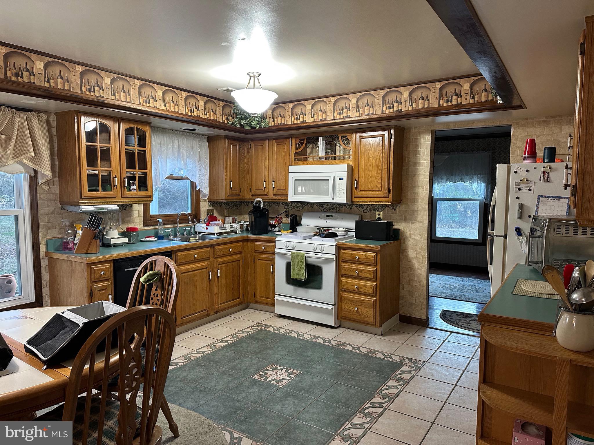 24 McIntosh Road Sewell, NJ 08080 - Photo 2 of 23 a kitchen with stainless steel appliances granite countertop a stove top oven a sink a dining table and chairs