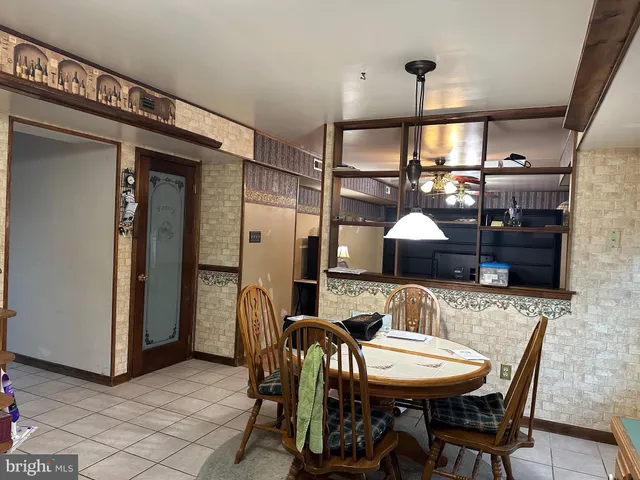 a dining room with furniture and a chandelier