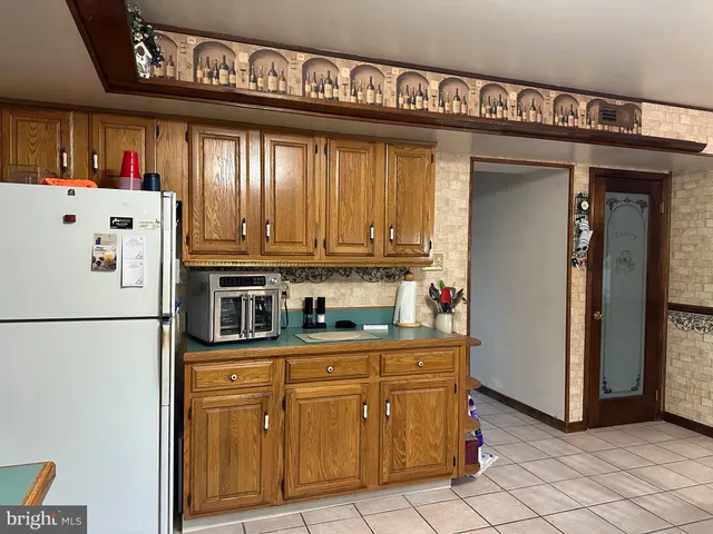 a kitchen with stainless steel appliances granite countertop a refrigerator and a stove