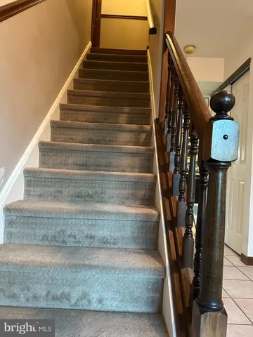 a view of staircase with white walls and a window