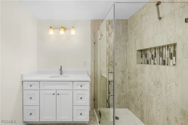 a bathroom with a granite countertop sink mirror and toilet