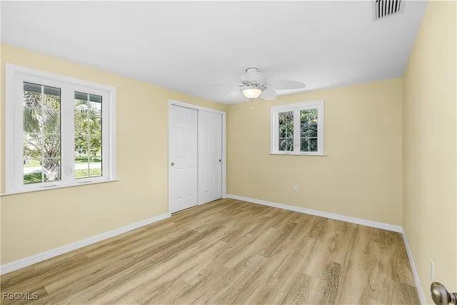 a view of a room with wooden floor and white walls