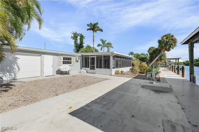 a view of a house with backyard and sitting area