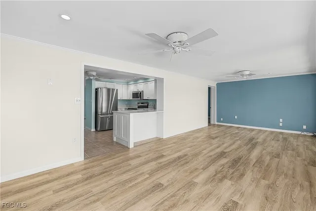 a view of a kitchen with a sink and a refrigerator