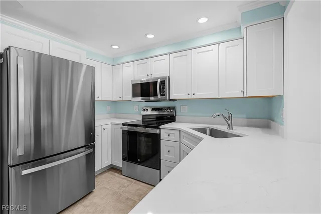 a kitchen with stainless steel appliances granite countertop a stove and a sink