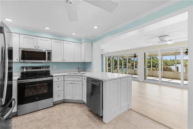 a kitchen with stainless steel appliances a refrigerator and a sink