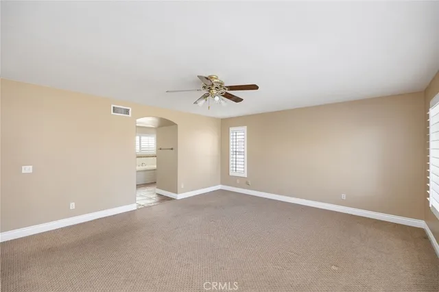 a view of a livingroom with a ceiling fan and window