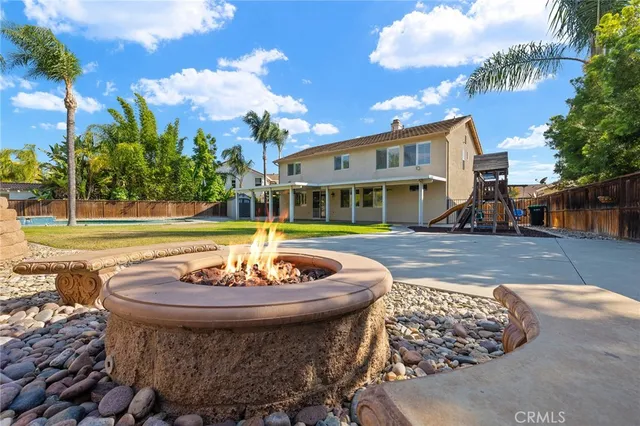a view of a house with a swimming pool and a sitting area