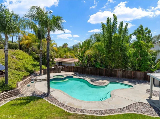 a swimming pool with outdoor seating and yard