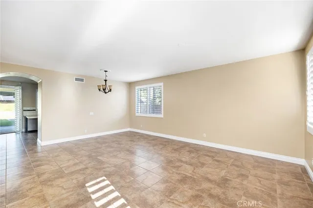 an empty room with windows and cabinet