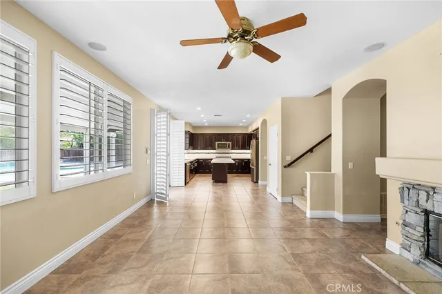 a view of a livingroom with furniture staircase and a ceiling fan