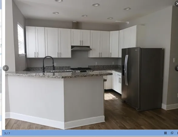 a kitchen with stainless steel appliances granite countertop a refrigerator sink and cabinets