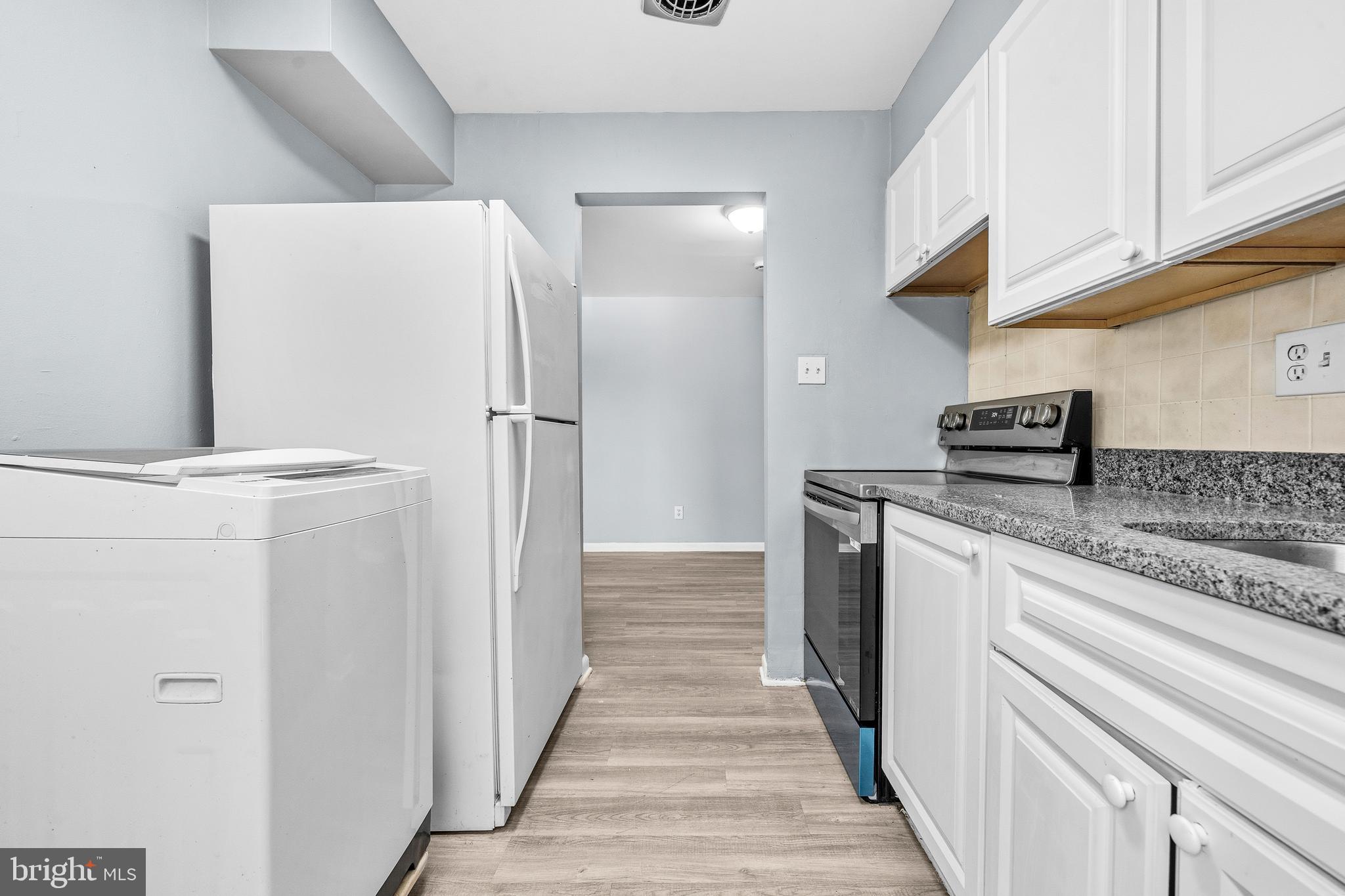 4260 Buckman Road, Unit 43 Alexandria, VA 22309 - Photo 13 of 35 a kitchen with stainless steel appliances granite countertop a refrigerator and a stove