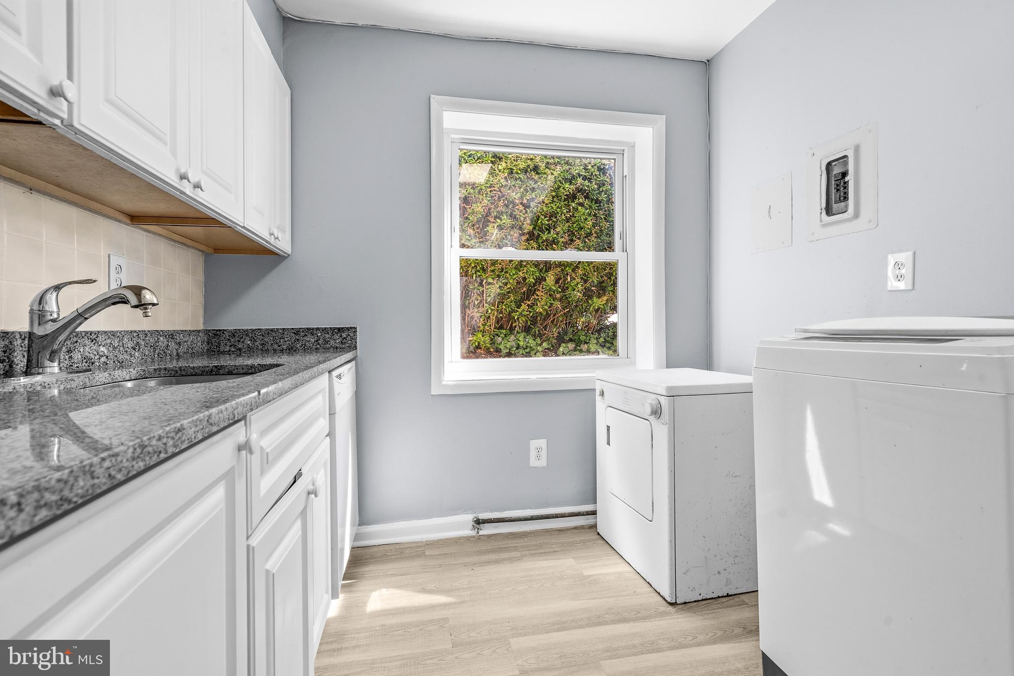 4260 Buckman Road, Unit 43 Alexandria, VA 22309 - Photo 14 of 35 a kitchen with a granite countertop sink and cabinets