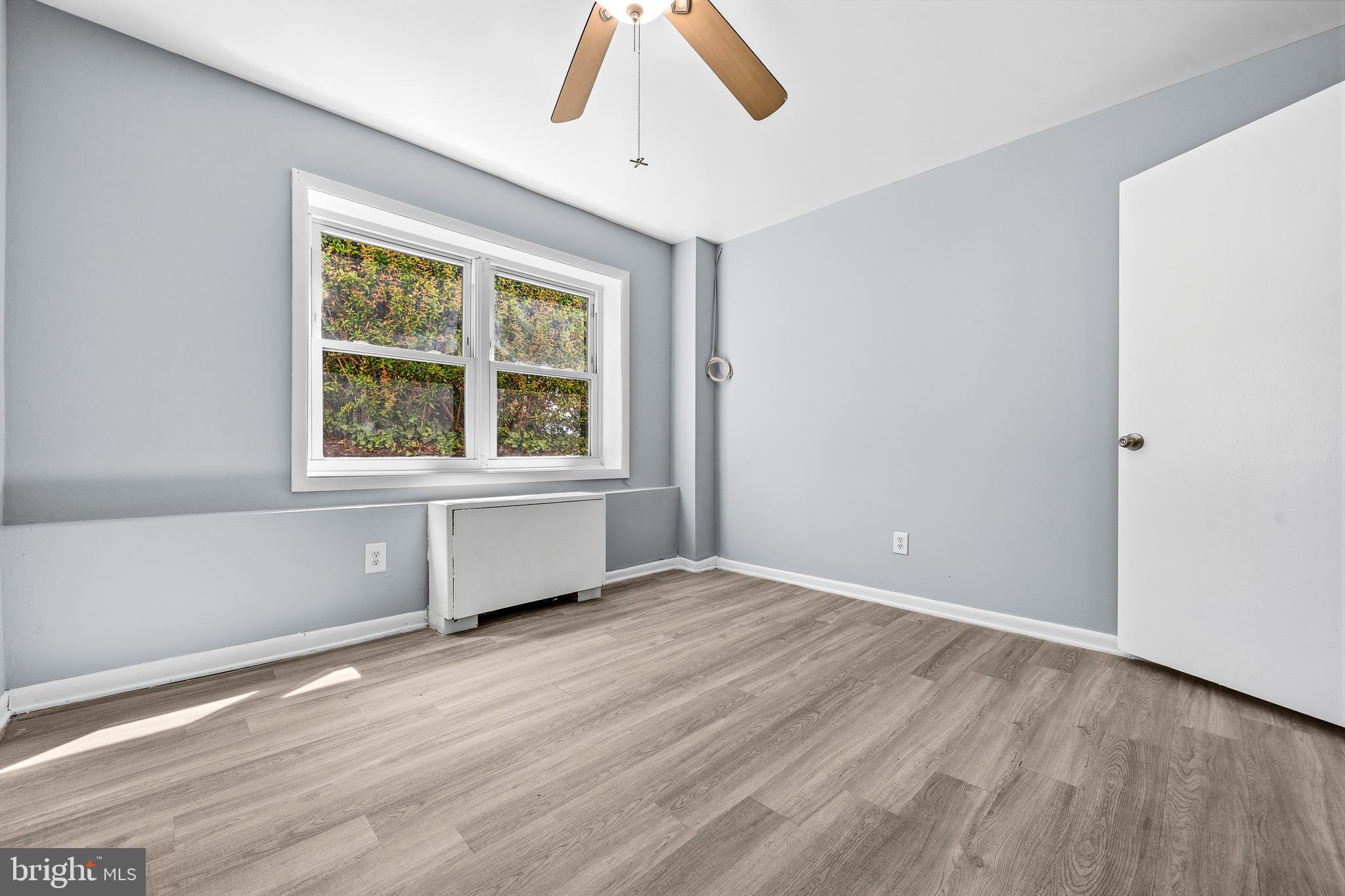 4260 Buckman Road, Unit 43 Alexandria, VA 22309 - Photo 17 of 35 an empty room with wooden floor and windows