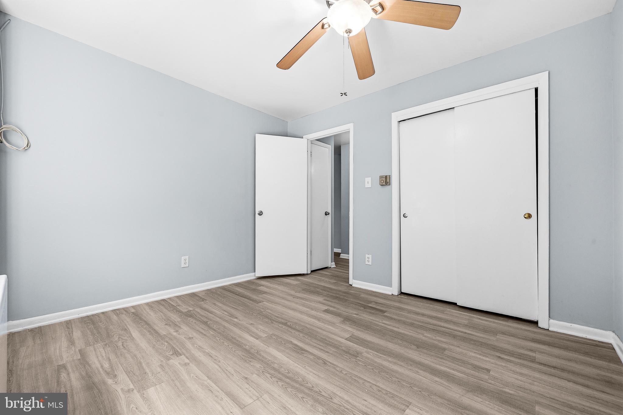 4260 Buckman Road, Unit 43 Alexandria, VA 22309 - Photo 19 of 35 an empty room with wooden floor chandelier fan and closet area