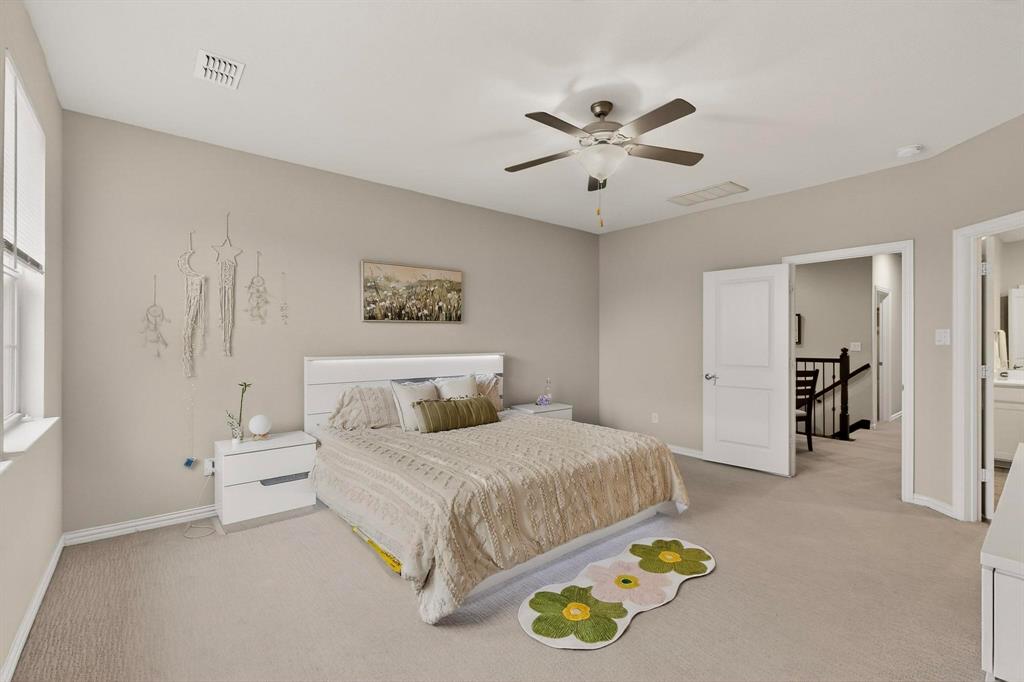 1027 Zachary Way Allen, TX 75013 - Photo 15 of 35 Upstairs primary bedroom with ceiling fan