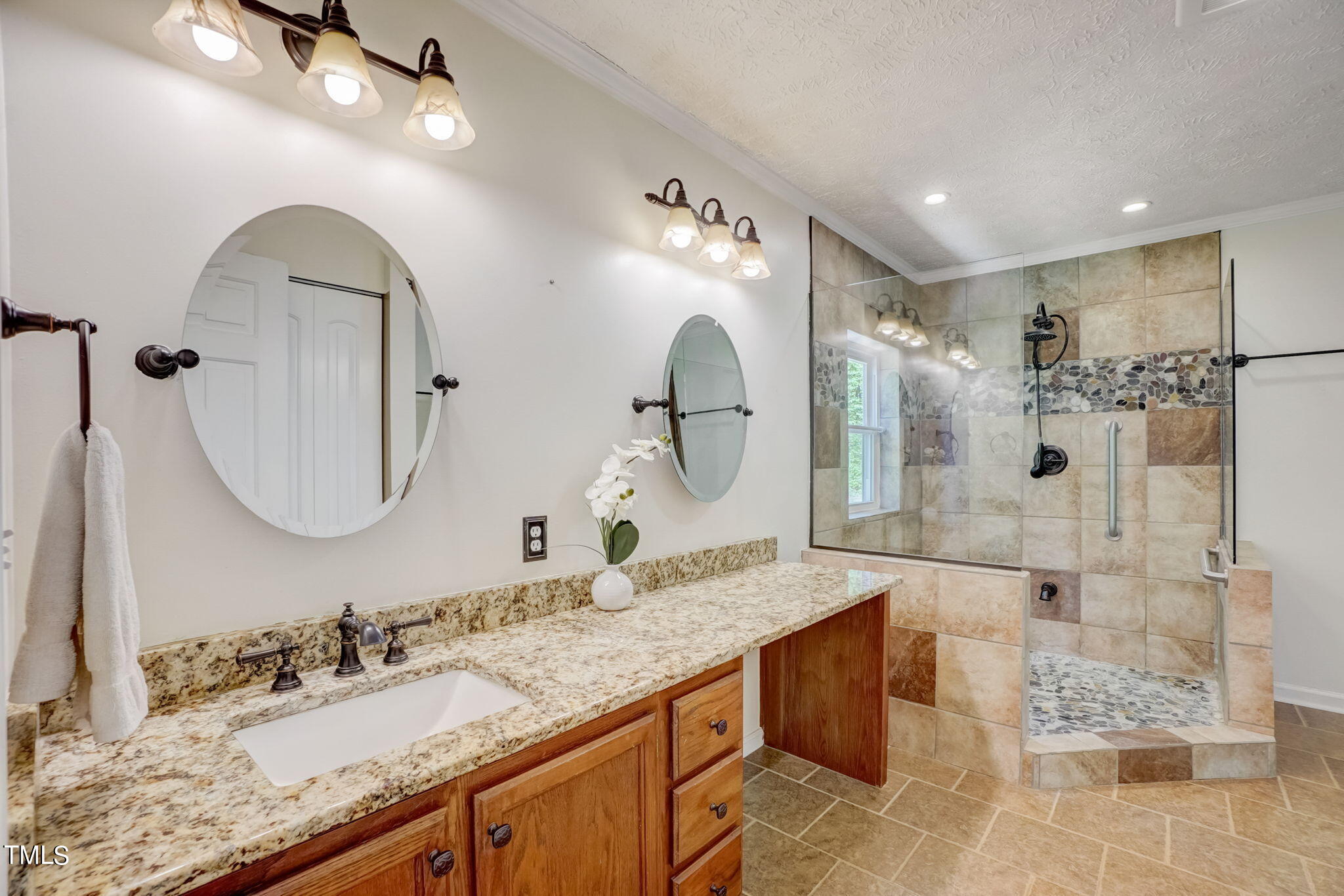 7204 New Sharon Church Road Rougemont, NC 27572 - Photo 14 of 48 a bathroom with a granite countertop sink mirror and shower