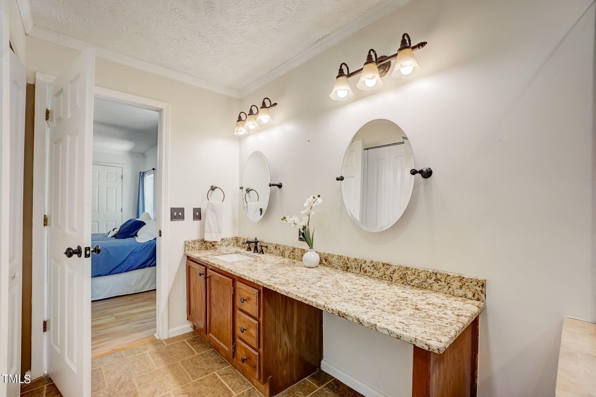 7204 New Sharon Church Road Rougemont, NC 27572 - Photo 16 of 48 a bathroom with a granite countertop sink and a mirror