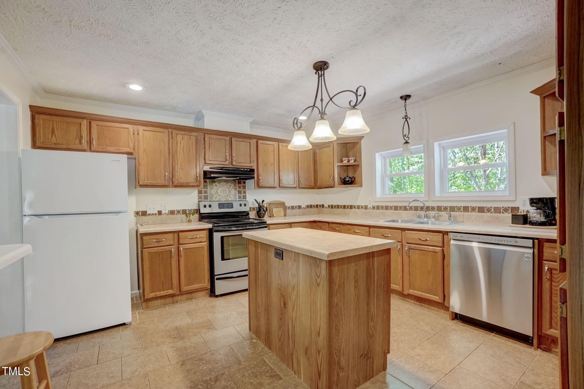 7204 New Sharon Church Road Rougemont, NC 27572 - Photo 10 of 48 a kitchen with stainless steel appliances granite countertop a sink a stove a refrigerator and a refrigerator