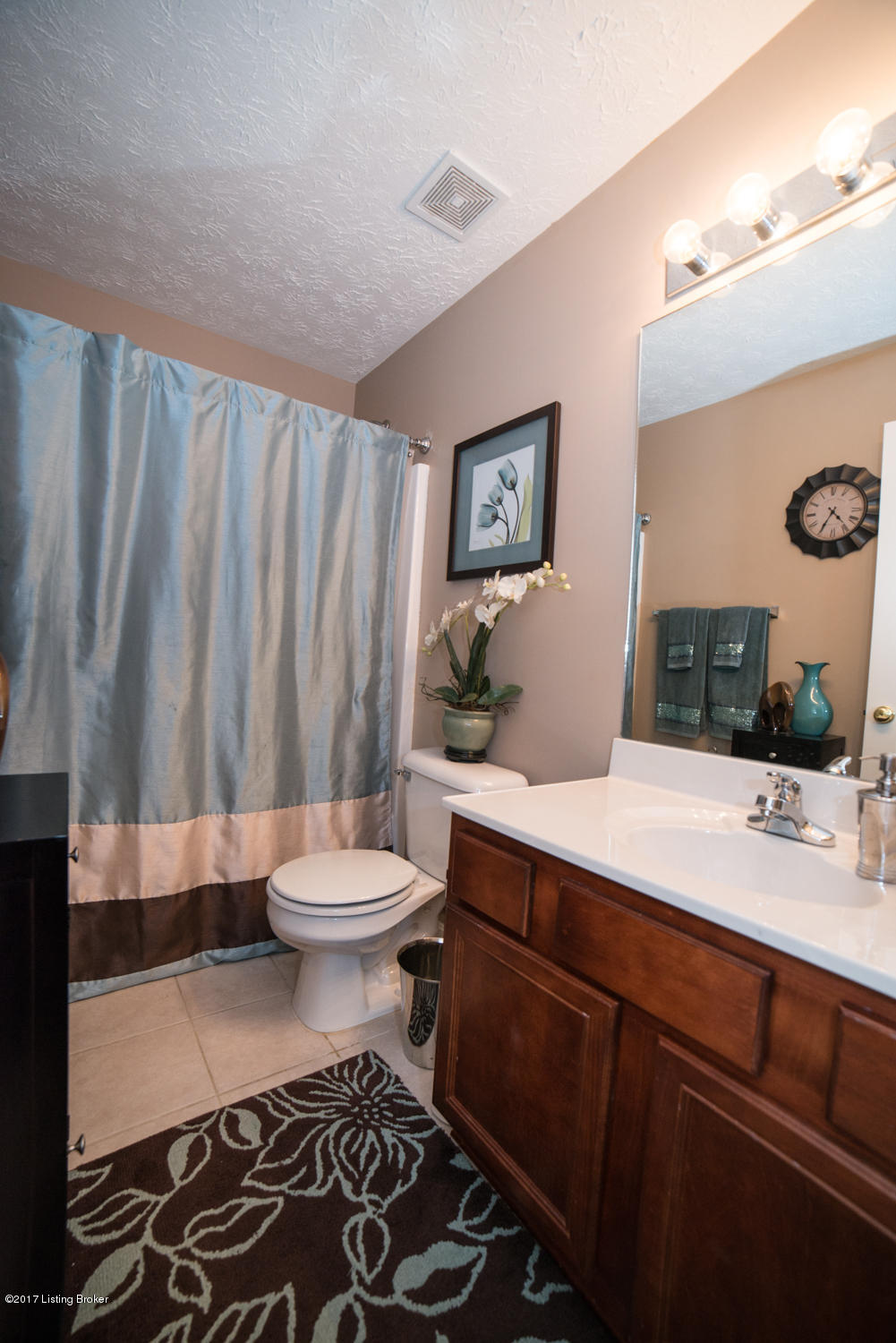 17520 Curry Branch Road Louisville, KY 40245 - Photo 25 of 45 The Full Bath is finished with wood vanity and linen cabinet, calming color palette and chrome fixtures