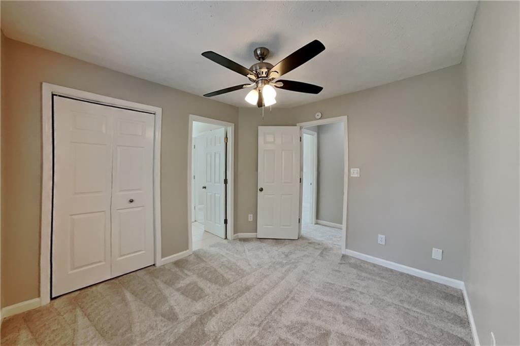 3366 English Oaks Drive Northwest Kennesaw, GA 30144 - Photo 16 of 22 a view of an empty room with a ceiling fan