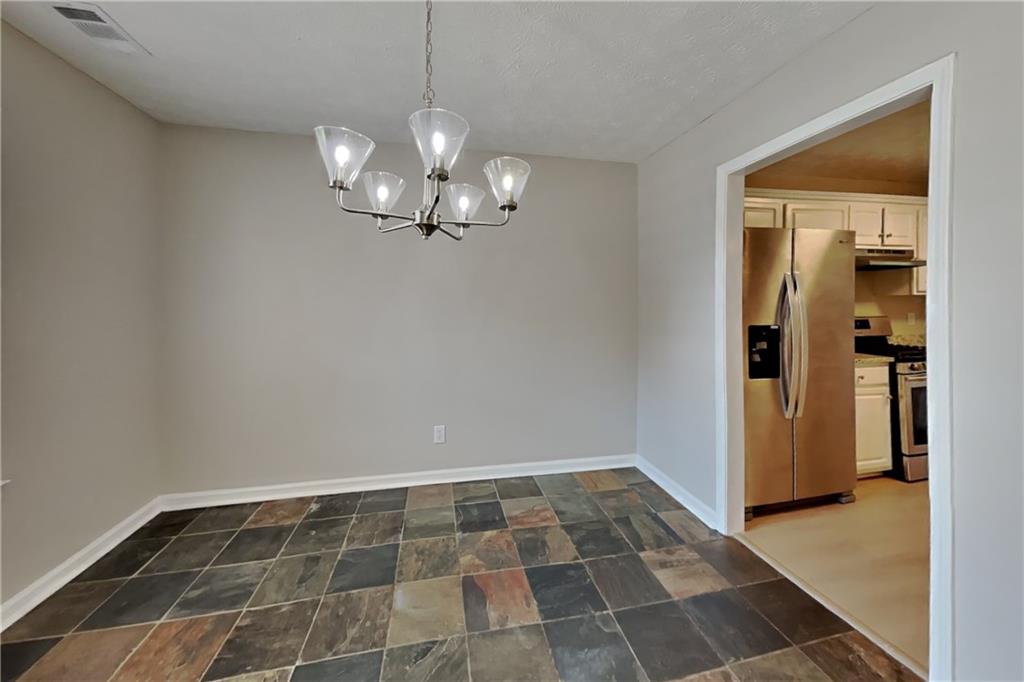 3366 English Oaks Drive Northwest Kennesaw, GA 30144 - Photo 8 of 22 a view of a hallway with wooden floor and a bathroom