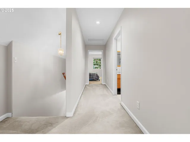 a view of a hallway with wooden shelves