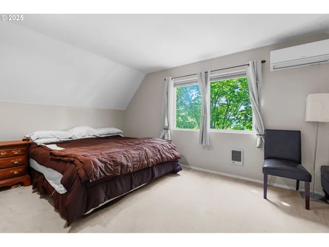 a bedroom with a bed and a chair