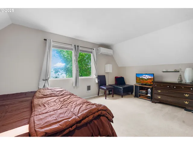 a bedroom with a bed and a large window