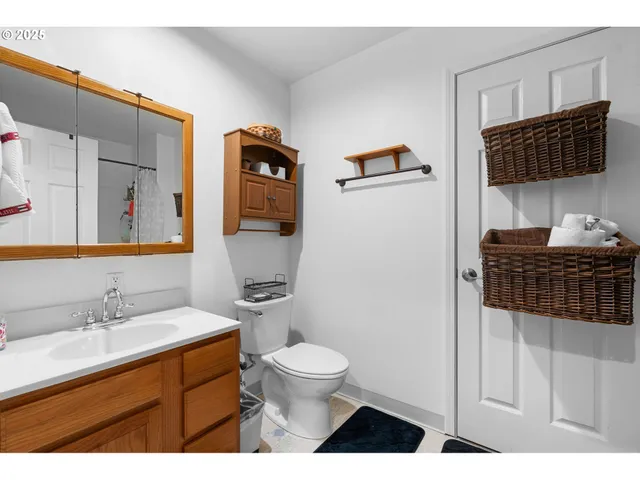 a bathroom with a sink toilet a mirror and shower