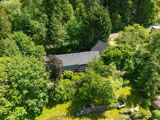 an aerial view of house with yard and outdoor seating