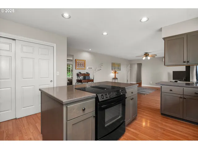 a kitchen with stainless steel appliances granite countertop a stove a sink and a microwave
