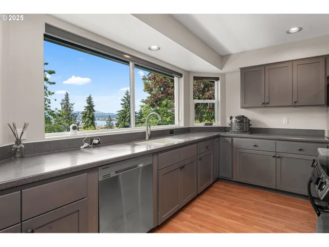 a kitchen with a sink and large window