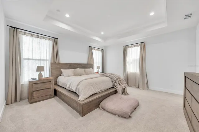 a bathroom with double vanity sink a mirror and a shower
