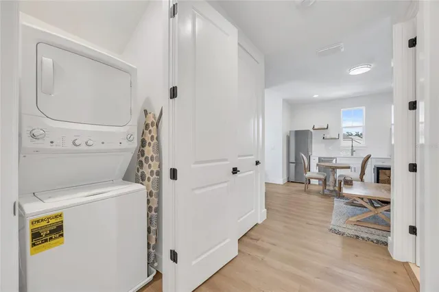 a dining room with furniture a potted plant and a chandelier