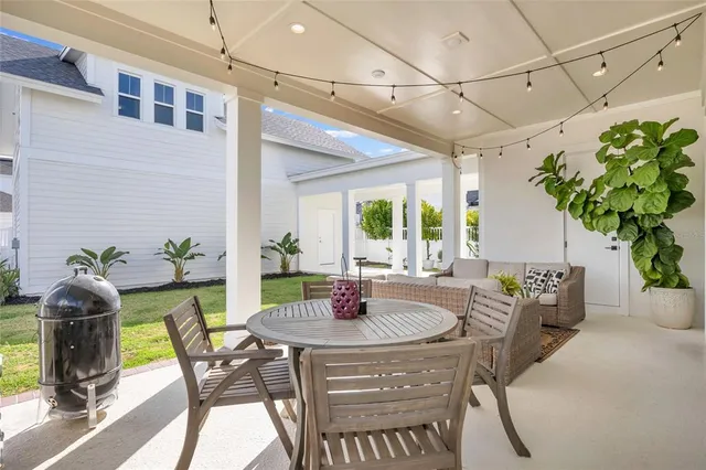 an aerial view of a house with a swimming pool and outdoor seating