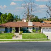 a front view of a house with a yard table and chairs