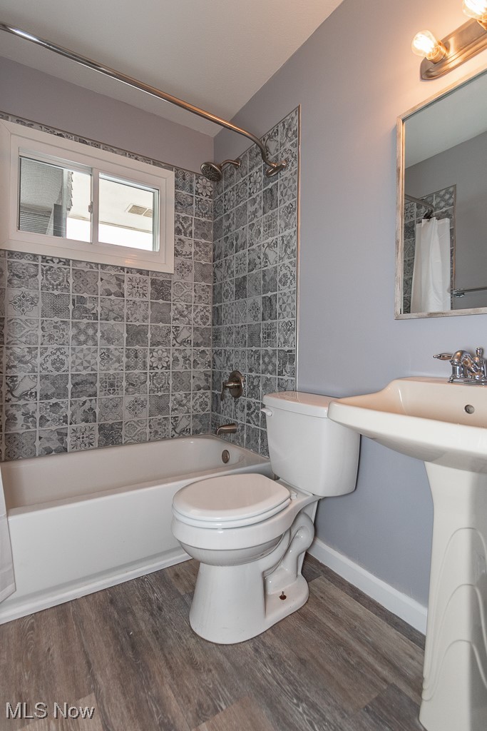7996 Munson Road Mentor, OH 44060 - Photo 12 of 33 Bathroom featuring hardwood / wood-style flooring, tiled shower / bath, and toilet