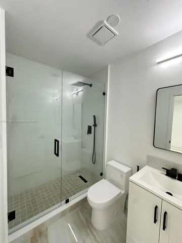 a bathroom with a toilet and a shower