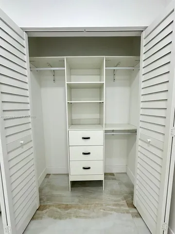 a view of storage and utility room with closet