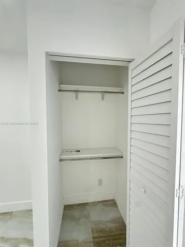 a view of a patio with couches under an umbrella