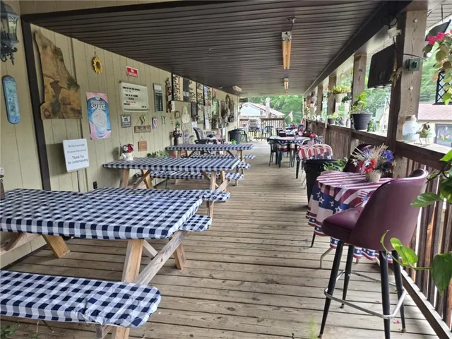 a view of a backyard with table and chairs potted plants and a palm tree