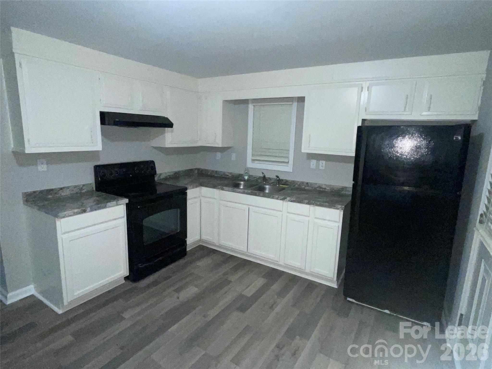 70 Barbee Road Southwest Concord, NC 28027 - Photo 2 of 7 a kitchen with a sink and a refrigerator