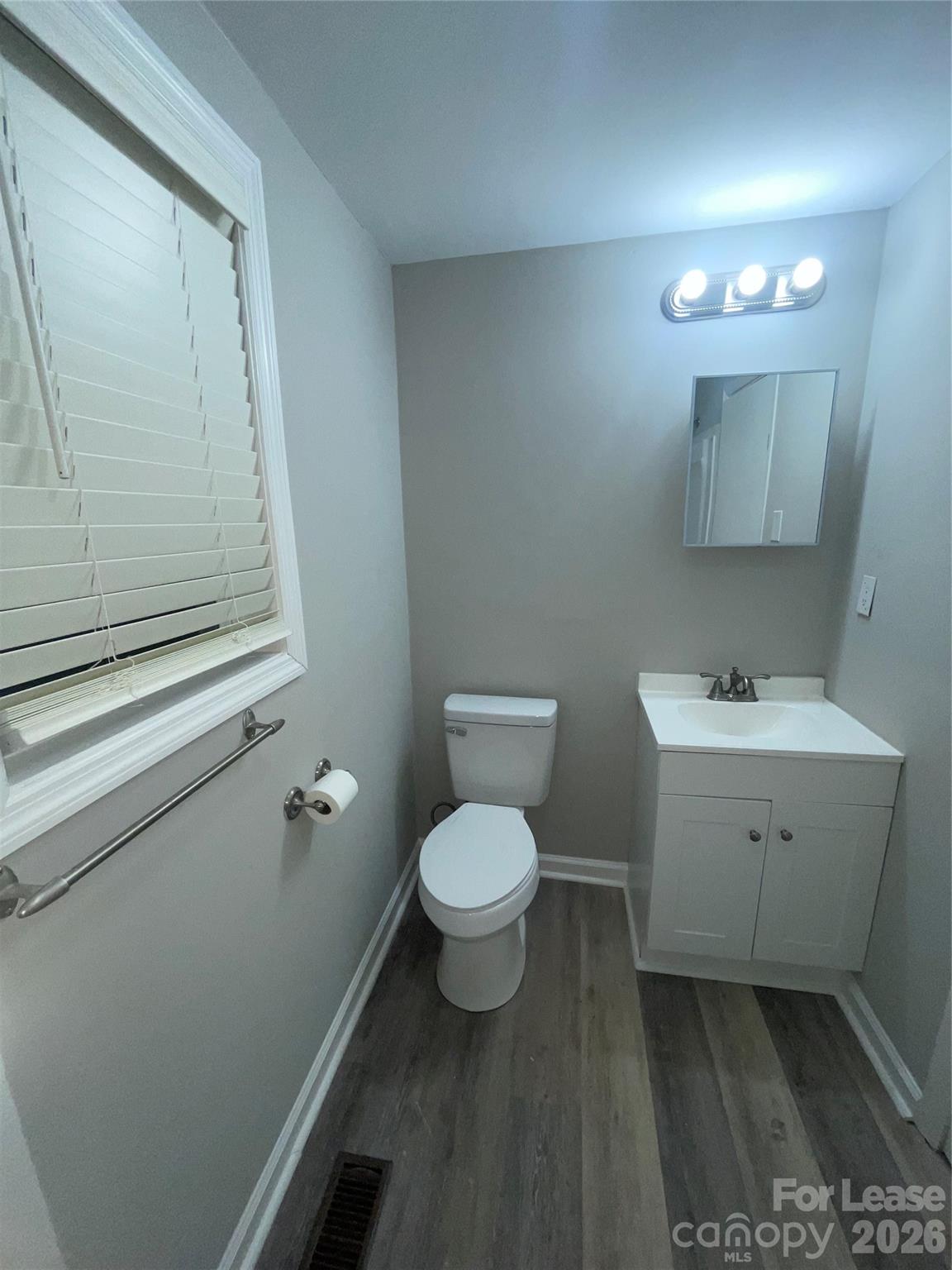 70 Barbee Road Southwest Concord, NC 28027 - Photo 4 of 7 a bathroom with a toilet sink and mirror