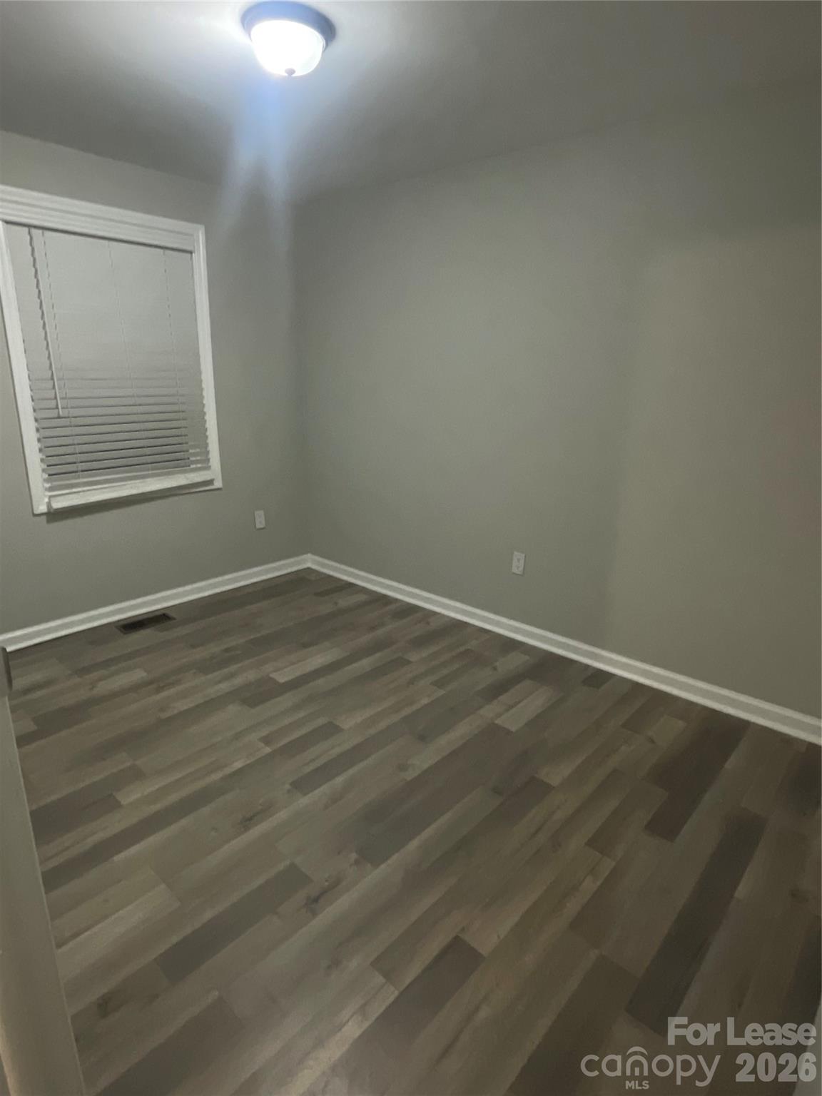 70 Barbee Road Southwest Concord, NC 28027 - Photo 6 of 7 a view of an empty room with wooden floor and a window