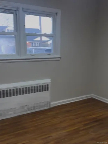 a view of wooden floor and a window